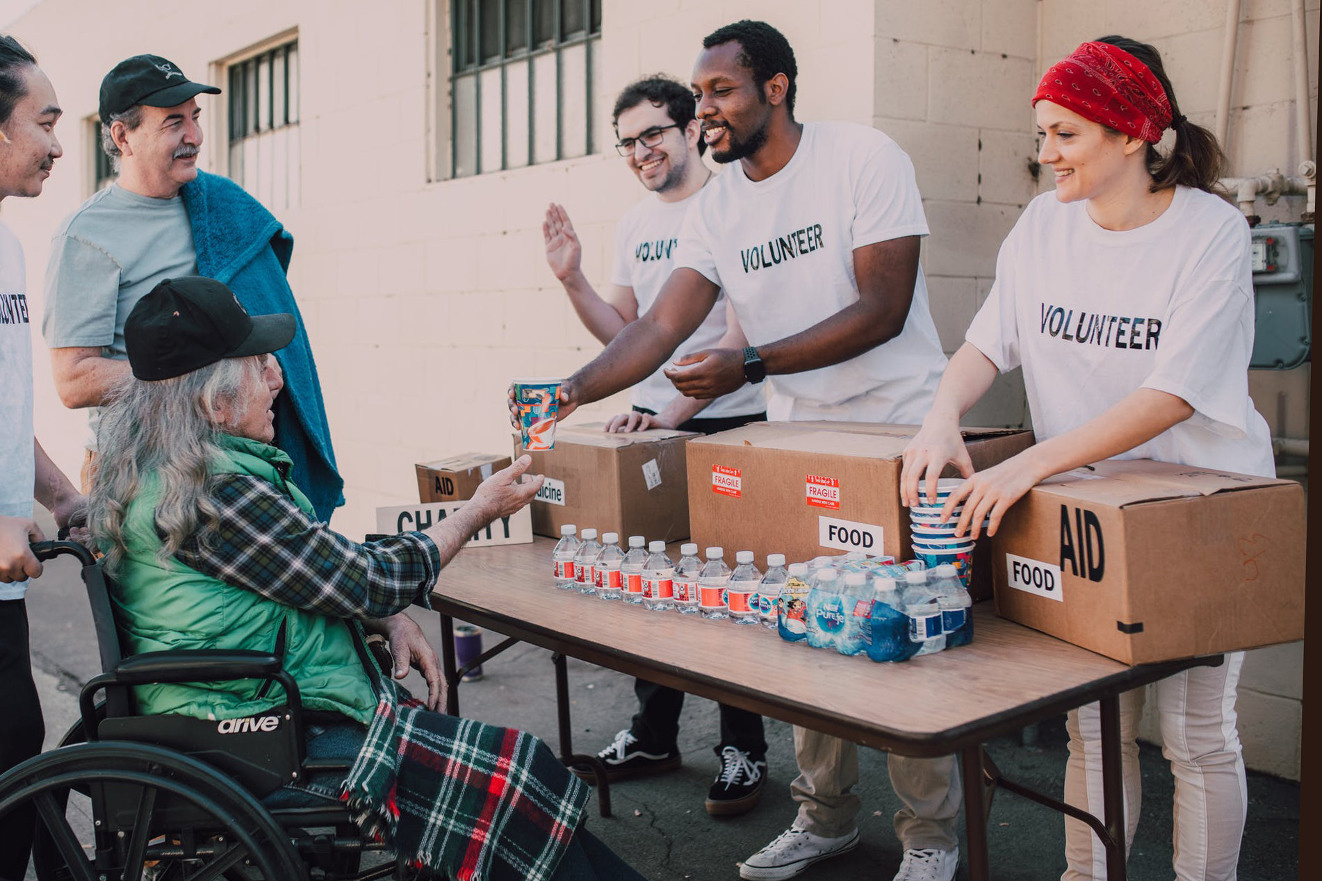 Student volunteers handing out water to community members